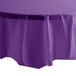 An amethyst purple plastic table cover on a white table.
