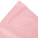 A Classic Pink plastic table skirt in packaging with a pink and white label.
