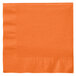 A close-up of a Creative Converting Sunkissed Orange 1/4 Fold Luncheon Napkin with a folded edge.