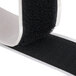 A roll of black Cactus Mat loop fastener tape with white trim.