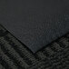 A black vinyl Pro-Tekt carpet runner mat on a carpet.