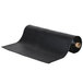 A rolled up black vinyl carpet protection mat.
