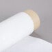 A roll of white material with a roll of white tape.