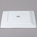 A white square Libbey porcelain plate with a logo on it.