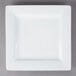 A white square Libbey porcelain plate with a white rim on a gray surface.