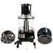A Waring commercial food processor with parts and accessories including a clear bowl and discs.