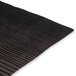 An American Metalcraft walnut melamine serving board on a black and white striped surface.