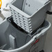 A grey Rubbermaid Executive WaveBrake mop bucket.