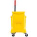 A yellow Rubbermaid mop bucket with a red wringer press.
