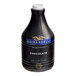 A black Ghirardelli bottle of chocolate flavoring sauce with a label.