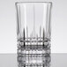 A clear Spiegelau Perfect Serve Longdrink/Collins glass with a curved edge.