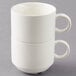 A stack of two white Arcoroc Daring porcelain coffee cups with handles.