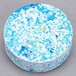 A round blue and white Unger The Pill glass cleaner concentrate tablet.