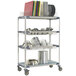 A MetroMax i mobile rack with metal shelves holding dishes and pots.