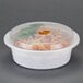 A white Pactiv plastic container with food inside.