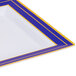 A close up of a Fineline square white plastic plate with blue and gold stripes.