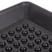 A black polypropylene pizza tray with small holes.