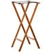 A Lancaster Table & Seating wooden folding tray stand with a black strap.
