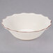 A white stoneware bowl with a brown rim.