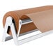 A Bulman white steel paper dispenser holding a roll of brown paper.