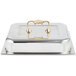 A silver tray with a Vollrath brass chafer cover handle.