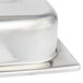 A close-up of a silver Vollrath classic brass chafer cover on a silver container.