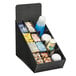 A black Vollrath countertop organizer with cups and lids inside.