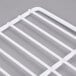 A close up of a white coated wire grid shelf.