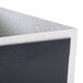 A close-up of a black and silver Menu Solutions Alumitique displayette box with a grey lid.