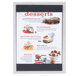 A brushed aluminum Menu Solutions triple view table displayette with top and bottom strips holding a menu of desserts.