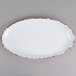 A white oval melamine platter with a brown border.