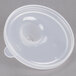 A close-up of a clear plastic lid with a hole over a white plastic bowl.