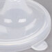 A close-up of a clear plastic lid with perforated openings.