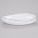 A white oval melamine bowl with a brown speckled design on the edges.