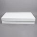 A white corrugated full sheet cake box with a lid on a gray surface.