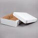 A white corrugated bakery box with a lid open.
