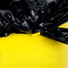 A black plastic bag on a yellow Continental Huskee trash can.