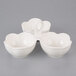 A white 3-tiered bowl caddy with 3 heart-shaped bowls on it.