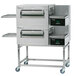 A Lincoln ventless double electric conveyor oven package with two large stainless steel ovens.