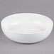 A 10 Strawberry Street Wazee Matte white stoneware serving bowl on a gray surface.