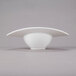 A close-up of a 10 Strawberry Street Somba white porcelain bowl with a curved rim on a gray surface.