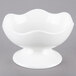 A 10 Strawberry Street Whittier white porcelain bowl with wavy sides and a small stand.
