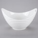 A white bowl with a ribbed texture on a gray background.