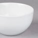 A 10 Strawberry Street Wazee Matte white stoneware bowl on a gray surface.
