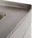 A close-up of a stainless steel floor mounted mop sink from Advance Tabco.