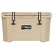 A tan Grizzly Cooler with black handles and a logo on the lid.