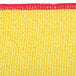 A yellow and red Unger SmartColor microfiber cleaning cloth with a red trim.
