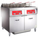 A Vulcan electric floor fryer system with two units on a counter in a school kitchen.