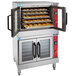 A Vulcan liquid propane double deck commercial convection oven with trays of food inside.