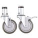 A pair of Vulcan metal casters with rubber wheels.